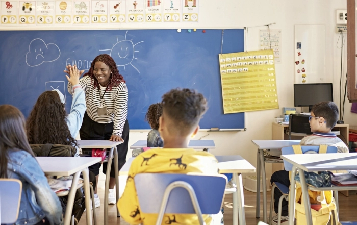 Kelvin Data - teacher high fiving student